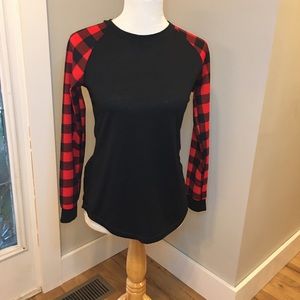 Black shirt with plaid long sleeves.